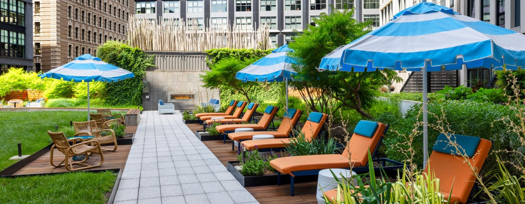 a patio with chairs and umbrellas