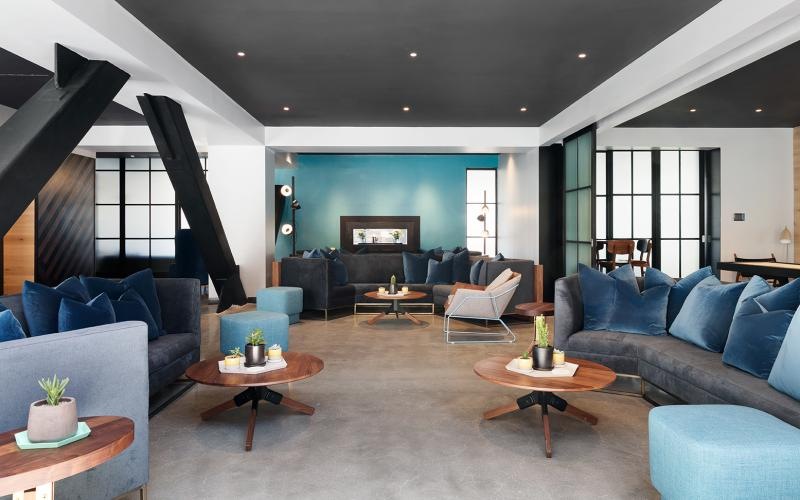 a living room with blue couches